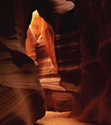 Narrow passage through a stone cavern.