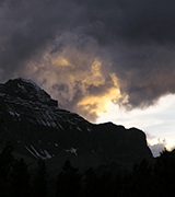 Dark storm clouds over a high mountain.