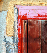 Old wooden door with a red frame.