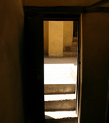 Open door with stone steps leading up.