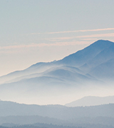 Misty hills receding in the distance.