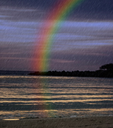 Rainbow at the beach in a storm.