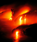 A burning lava flow at night.