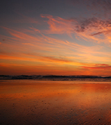 Sunset over a still bay.