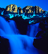 Blue waterfall beneath the mountains.