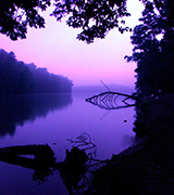 Sunrise over a still river.