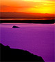 Orange sunset over a violet lake