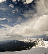Clouds over a high mountain ridge.
